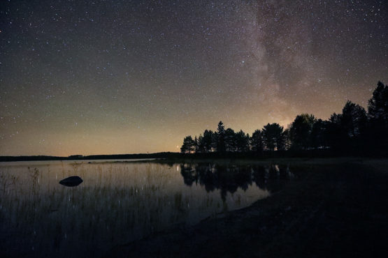 Photo shows the Milky Way and the bright reflection of the planet Mars on lake Korpijarvi at Villa Cone Beach.