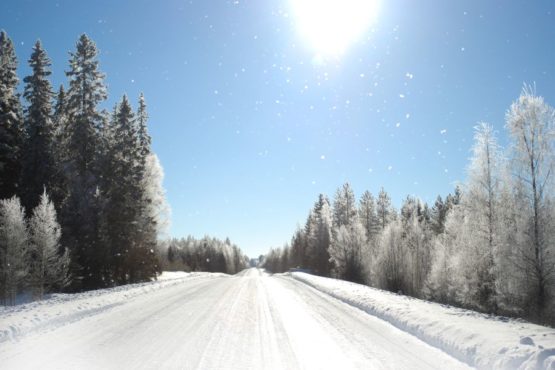 Photo shows the winter sightseeing road from Villa Cone Beach to Kuhmo town center. Wind flies snowflakes in a very bright sunshine.