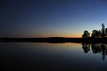 Photo shows mysterious atmosphere at Villa Cone Beach lakeside in a sumer midnight.