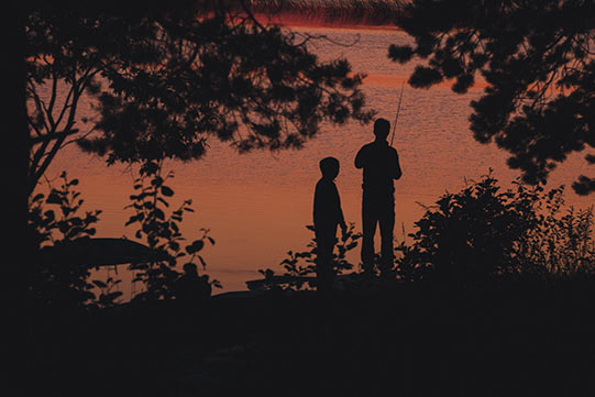 Villa Cone Beach Fishing Angling Photo shows two small boys having their favourite summer activities, angling fish in a dusk.
