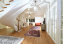 Photo shows Villa Cone Beach living room, antique oriental carpets and the curved stairs up to the bedrooms.