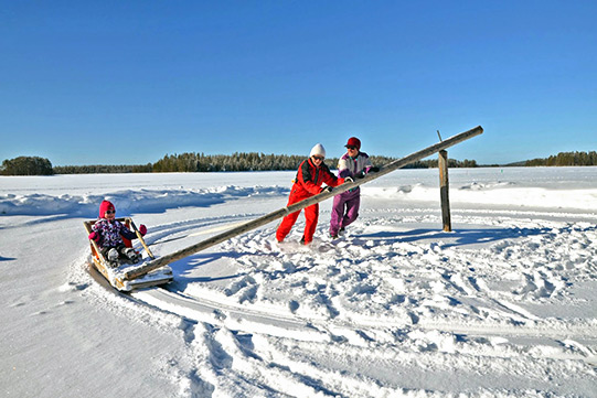 Winter fun with a merry-go-round sledge in winter wonderland.