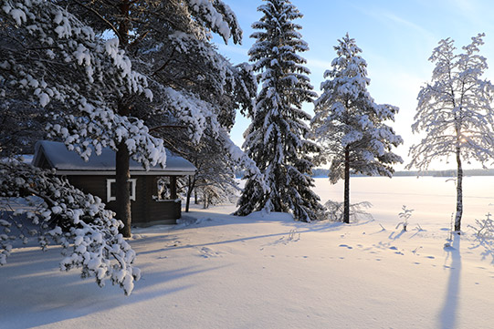 Photo shows Villa Cone Beach lakeside sauna facing the snowy Lake Korpijarvi.